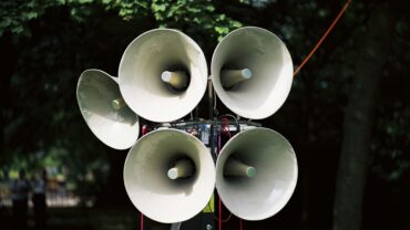 cluster-of-megaphones-on-a-stand-in-a-park-setting